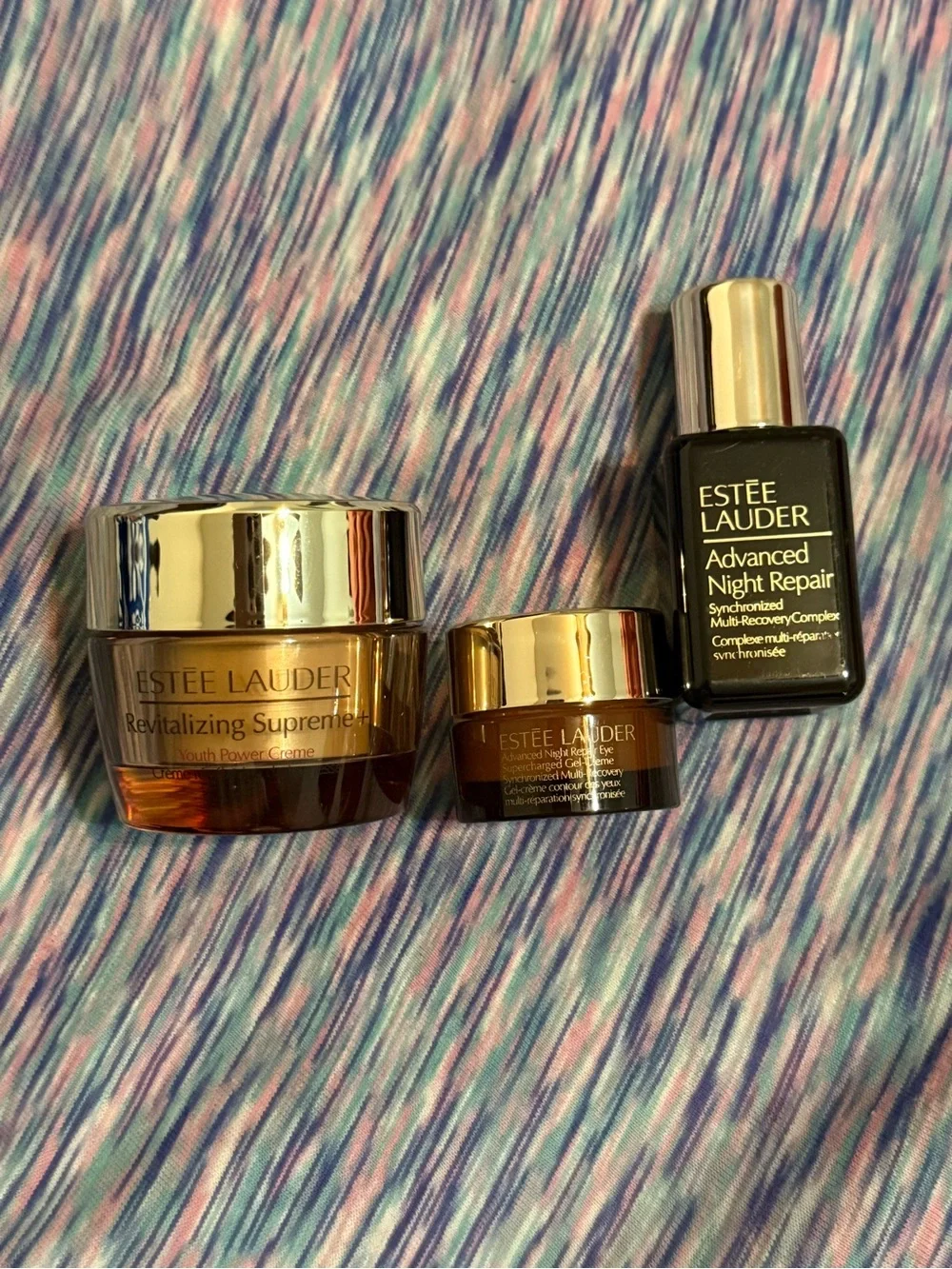 Estée Lauder gold and amber skincare jars and bottle